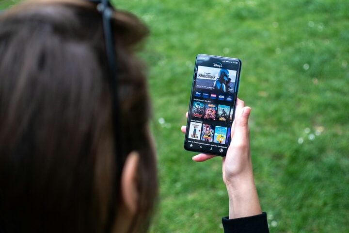 woman holding black android smartphone