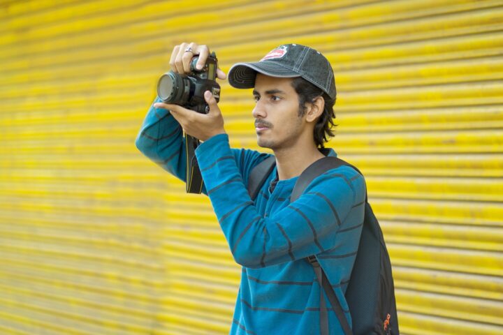a man holding a camera up to take a picture