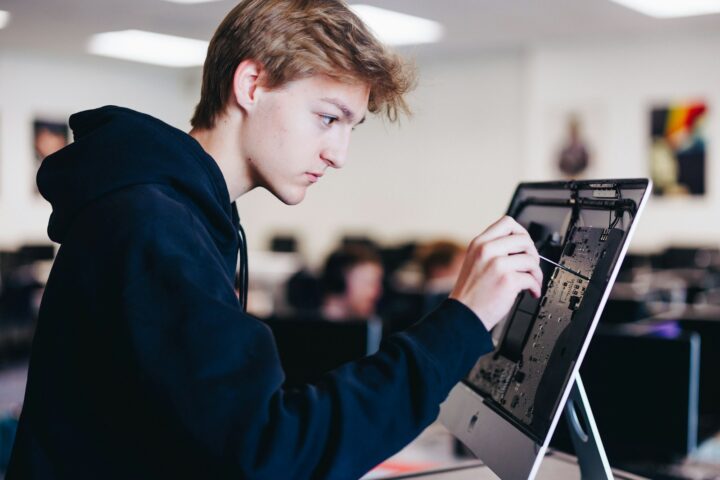 a young man working on a laptop computer