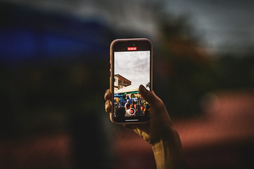 A person taking a picture with a cell phone
