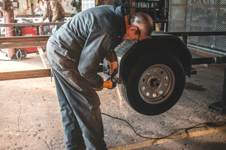 man fixing a vehicle tire
