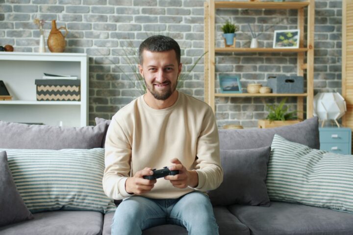 Man playing video games on a couch
