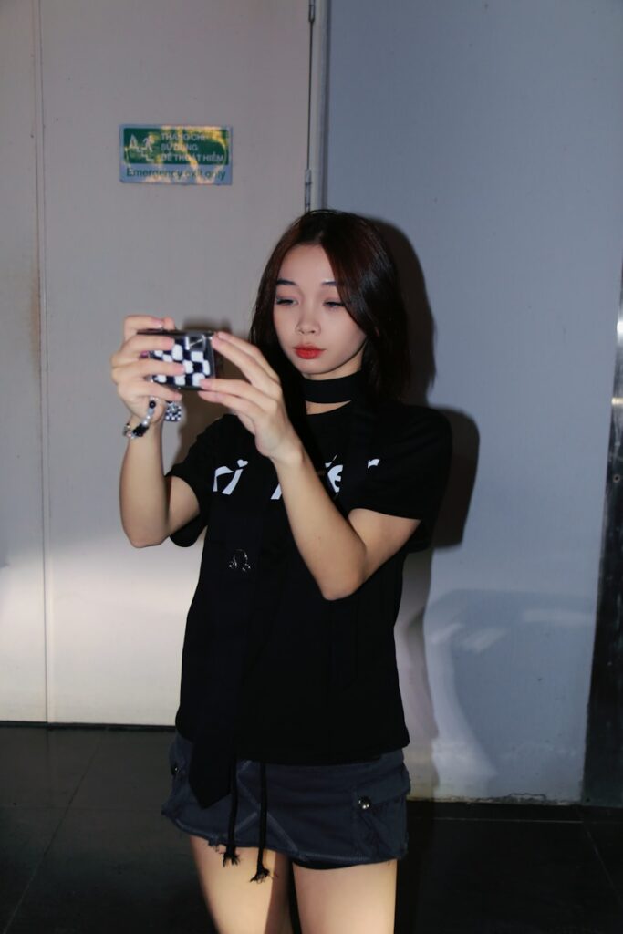 a woman taking a picture of herself in a mirror