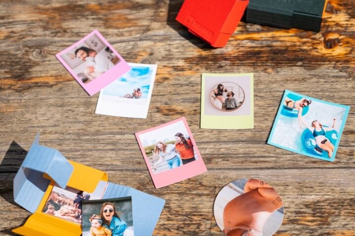a wooden table topped with pictures and magnets