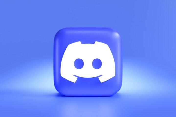 a square button with a smiley face on a blue background