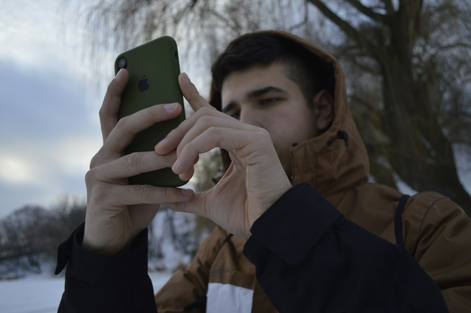 a man holding a cell phone up to his face