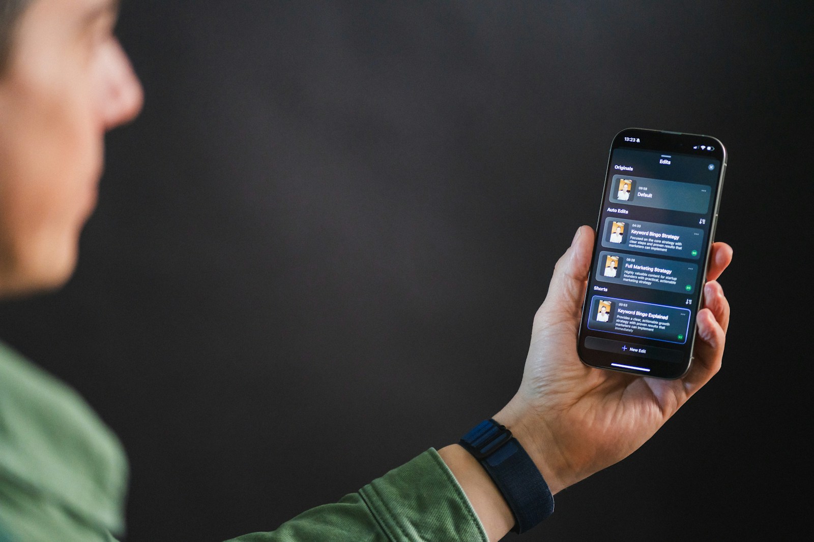 Man holding smartphone with app interface