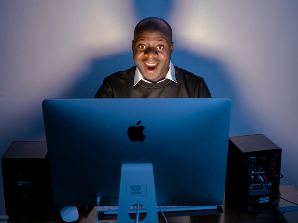 a man sitting in front of a computer on a desk