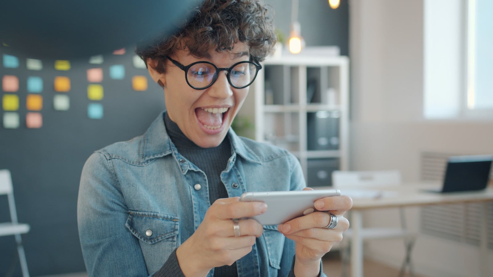 Excited woman playing a game on her phone
